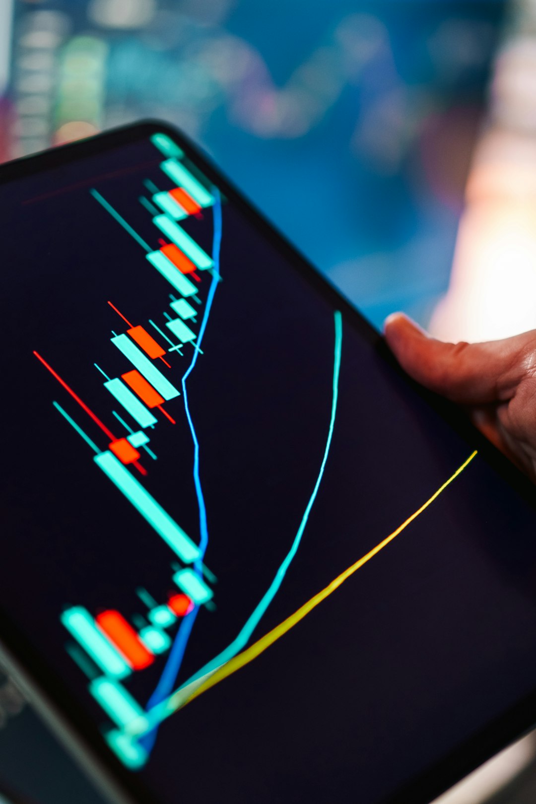 Financial trading candlestick chart tablet market analysis tablet screen Close up tablet screen showing rising price movement technical indicators trend lines digital finance data visualization investment technology editorial concept